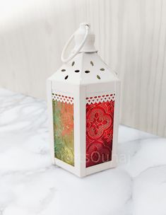 a white lantern sitting on top of a table