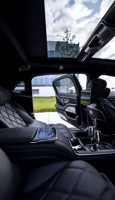 the interior of a luxury car with its sunroof and rear view mirror visible