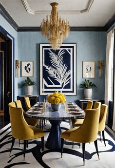 an elegant dining room with blue walls, yellow chairs and a chandelier hanging from the ceiling