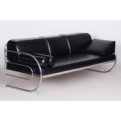 a black leather couch with chrome legs on a white background