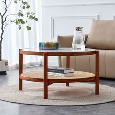 a coffee table with books on it in a living room area next to a couch