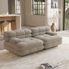 a couch sitting on top of a white rug in a living room