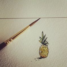 a drawing of a pineapple on paper with a brush