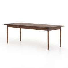 a wooden table sitting on top of a white floor