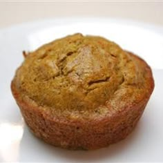 a muffin sitting on top of a white plate