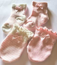 4 piece set of baby socks and matching mittens.  These are darling lil socks and mittens that come in solid pink and pink and white stripes. You will recieve two pairs of socks with matching mittens.  Trimmed with tiny satin bows completes the cutest set.  Perfect for a baby shower gift! This set is for newborns.  They are made of cotton, nylon and spandex. Machine washable and dryable. Will come packaged on a cute cardstock card with a cellophane  envelope for gift giving! 2 complete sets....$1 Cute Pink Winter Socks, Cute Soft Pink Socks, Sweet Pink Socks For Gifts, Pink Socks For Playtime In Winter, Pink Winter Socks For Gift, Pink Winter Socks For Gifts, Pink Winter Socks As Gift, Soft Pink Socks For Gift, Pink And White Stripes