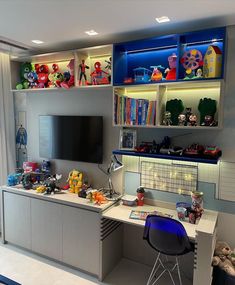 a child's room with toys on the shelves and a television mounted to the wall