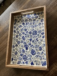 a blue and white plate sitting on top of a wooden table