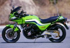 a green and black motorcycle parked on the street