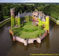 an aerial view of a castle in the middle of a river