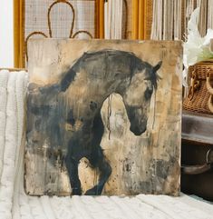 a painting of a horse on a canvas next to a basket with flowers in it