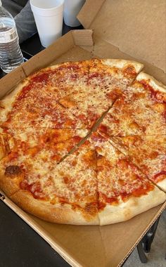 a large pizza sitting in a box on top of a table