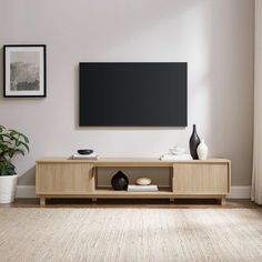 Whether youre into art-deco design, Japandi interiors, or a modern motif, this is the TV stand youve been looking for. With its sleek and subtle hardware, reeded double doors, and fuss-free open storage cubby, your tech will be perfectly perched in style. Its low-profile leaves room for you to display your wall-mounted TV, dcor, or wall art, yet it offers enough open and closed storage for all your entertainment center essentials. A warp-resistant MDF wood build and stunning yet durable laminate finish lends form, function, and a fashionable aesthetic. Available for Online Purchase Only. Ships Directly from the Manufacturer. RC Willey Delivery is Not Available. Assembly required. Made with warp-resistant MDF and durable laminate Fluted-door lends a luxe look Minimalist metal hardware Accom Simple Media Console, Natural Wood Entertainment Center, Light Oak Tv Stand, Entertainment Center Ideas Minimalist, White Oak Tv Console, Japandi Tv Console, Japandi Tv Stand, Light Wood Tv Stand, Minimalist Entertainment Center