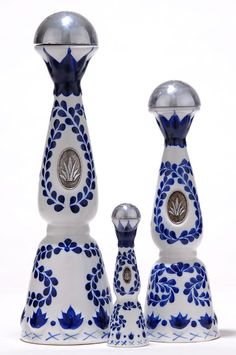 two blue and white vases sitting next to each other