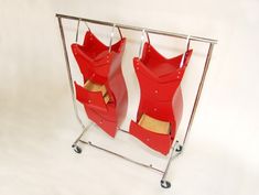 two red plastic bags are on a metal rack