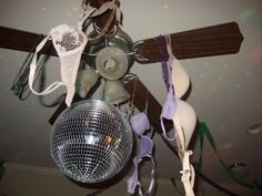 a mirror ball hanging from the ceiling next to other items