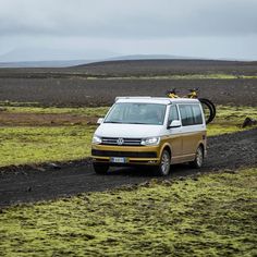 a white van driving down a dirt road