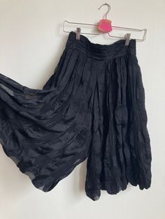 "Stunning, inky black check pattern puckered silk pleated culottes by YSL. Made in France. Leg is a balloon shape, and rise is extra high. Wide waistband, zips up in back and closes with a row of 3 buttons. Pockets at each hip. Semi-sheer and double layered.  Excellent condition.  Waist, across: 13\", 13.5\" pulled taut Rise: 18\" Inseam: 13.5\" Hip: free/open Please ask any questions before purchasing, especially concerning fit or condition. All items are vintage and in condition as described. Shipping via USPS Priority Mail unless otherwise agreed upon. All sales final, no returns- Thank You from Collecting Dust!" Summer Evening Bottoms With Pleated Waist, Pleated Silk Bottoms For Evening, Spring Bottoms With Accordion Pleats For Night Out, Black Pleated Wide Leg Culottes, Chic Black Bottoms With Accordion Pleats, Black Accordion Pleats Bottoms For Night Out, Black Pleated Hem Bottoms For Summer, Fitted Silk Pleated Bottoms, Chic Pleated Black Culottes