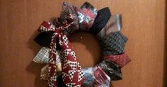 a close up of a wreath made out of different types of ties on a door