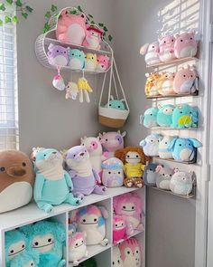 a room filled with lots of stuffed animals next to a wall mounted air conditioner