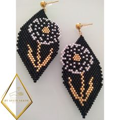 the beaded earrings are designed to look like an image of a black and white cat