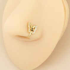 a close up of a ring on a mannequin's head with a butterfly