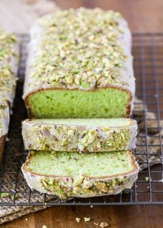 a loaf of green tea cake on a cooling rack with slices cut off and ready to be eaten