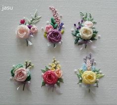 four different types of flowers on a white surface