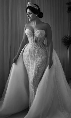 a woman in a wedding dress posing for the camera