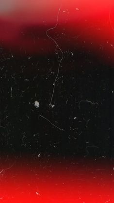 a black and red background with small white dots on the left side of the image