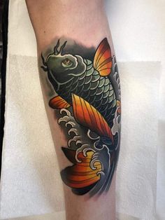 a fish tattoo on the leg