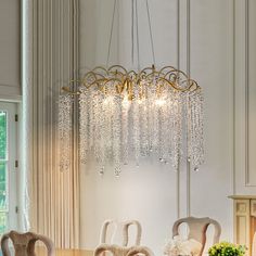 a chandelier hanging from the ceiling in a dining room