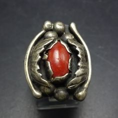 VINTAGE CORAL RING DESCRIPTION:  This exquisite ring features a cab of old red Mediterranean coral set in heavy gauge sterling silver. Applied leaves and raindrops flank the gemstone, and a band a twisted sterling silver wire bisects the split shank band. This fabulous ring will be a cherished addition to your collection of quality vintage Southwestern and Native American jewelry. MEASUREMENTS:  Ring face measures 7/8" x 3/4" RING SIZE:  8 1/4 WEIGHT:  8.5 grams SIGNED:  ƎE STERLING:  unmarked, Collectible Red Rings With Polished Finish, Collectible Red Gemstone Rings, Vintage Red Hallmarked Signet Ring, Unique Red Ruby Ring Collectible, Unique Red Ruby Ring For Collectors, Red Antique Collectible Jewelry, Vintage Sterling Silver Ring With Polished Finish, Vintage Red Signet Ring, Red Heirloom Jewelry For Collectors