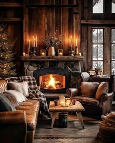 a living room filled with furniture and a fire place in the middle of a wooden wall