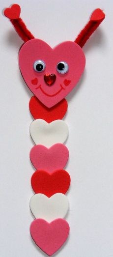 a red heart hanging from the side of a wall with two hearts attached to it