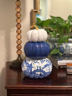 three blue and white pumpkins stacked on top of each other