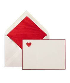 an open envelope with a red heart on the front and white paper in the back