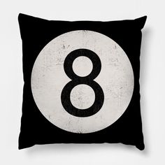 a black and white throw pillow with the number eight on it's front side