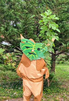 a person in a cat costume standing next to a tree