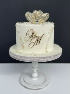 a wedding cake with two hearts on top