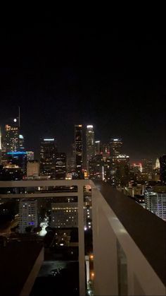 the city skyline is lit up at night