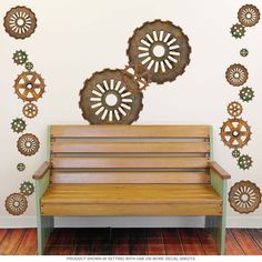 a wooden bench sitting in front of a wall with gears on it's back