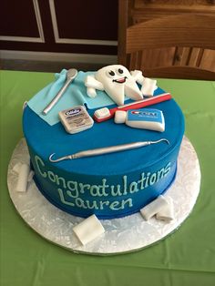 there is a cake that says congratulations lauren on the top and it's decorated with medical equipment