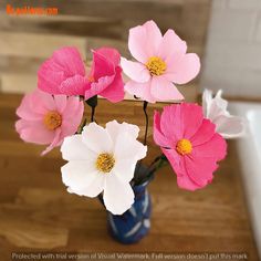 pink and white flowers in a blue vase