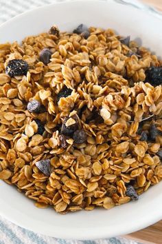 a white bowl filled with granola and raisins