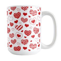 a red and white coffee mug with hearts on it