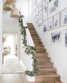 the stairs are decorated with greenery and pictures