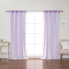 a living room with white walls and purple curtains