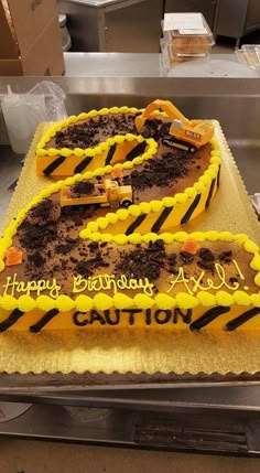 a birthday cake that is shaped like the number twenty five with construction equipment on it