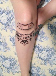 a person with a tattoo on their leg that says, everything is fine in it